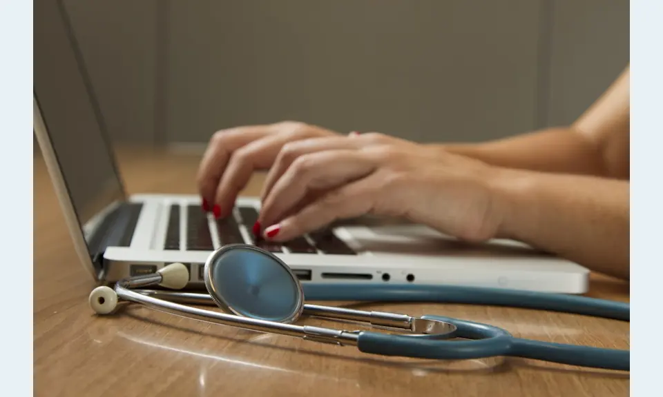 Flusso di accettazione della clinica con stetoscopio e laptop.